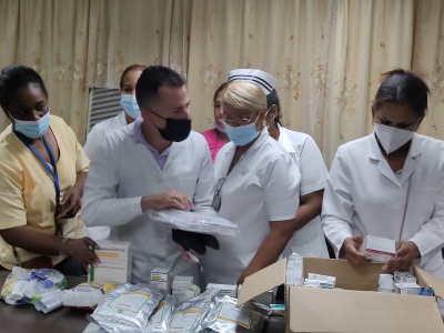 Ärzte und Ärztinnen des Provinzkrankenhauses "Dr. Agostinho Neto" in Guantánamo begutachten die mitgebrachten Medikamente und Materialien, die v.a. in der Chirurgie und Onkologie zum Einsatz kommen sollen. Foto: Cuba sí 